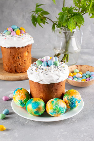 Easter bread. Cakes with icing. Spring festival 2022. Kulich. Happy Easter day. Cake with raisins....