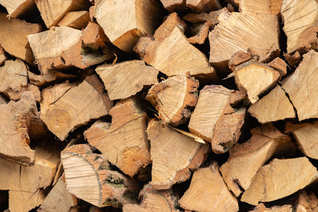 Stacked firewood. Preparation of firewood for the winter. Stocks of wooden firewood. Stacked...