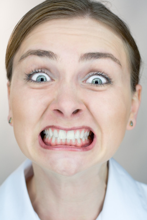 Closeup of a woman's face with uptight expression.の写真素材