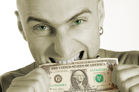 Man with earring biting a dollar bill. Photo colorized green in man's eyes and green on dollar bill. の写真素材