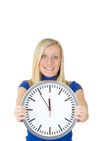 Half body portrait of smiling blond haired teenager with large clock, isolated on white background.の写真素材