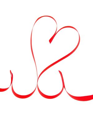 Close-up of a ribbon made red hearth の写真素材