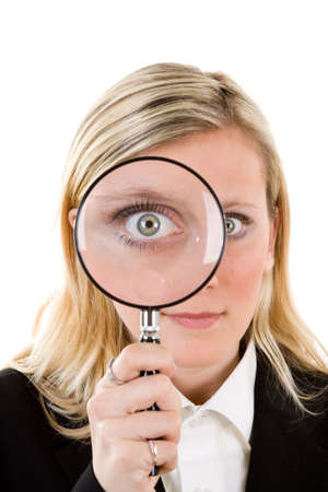 A woman with a magnifying glass over her eye. の写真素材