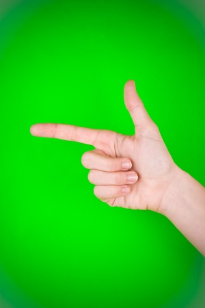 A closeup of a hand, with the last 3 fingers clenched and the thumb and index fingers spread out to form a gun/shooting gesture or pointing gesture.の写真素材