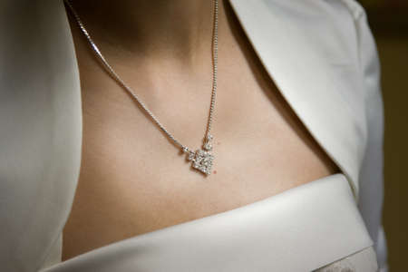 Woman in white dress wearing diamond necklace.の写真素材