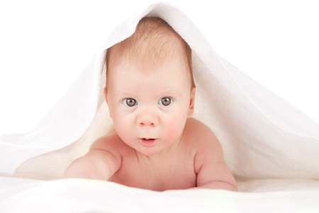 Portrait of a cute little baby boy covered with a blanket on his head. Image isolated on white studio background.の写真素材