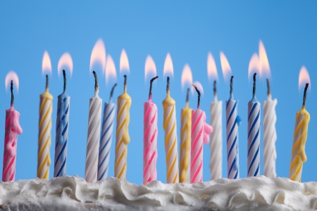 beautiful birthday candles on blue background の写真素材