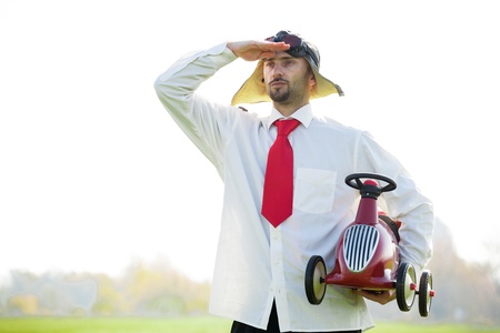 A racecar driver with a tie and a toy car. の写真素材
