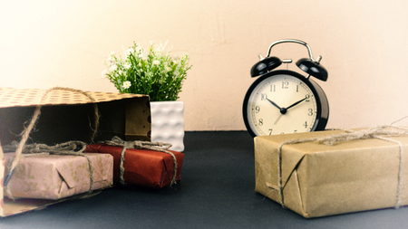 Package with gifts and an alarm clock concept of a holidayの写真素材