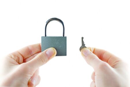 Opened lock and key in hand doorの写真素材
