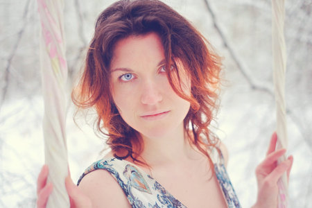 The girl on the swing in the winter forest mystery
