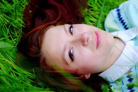 Girl in the grass woman, lying young, podcast happyの写真素材