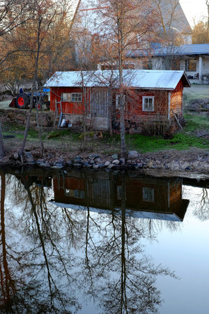 Red house on the lake norway, lake cottage sweden swedishの写真素材