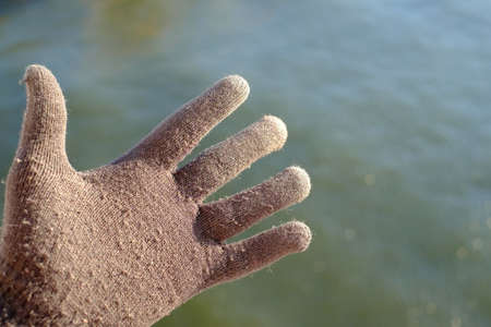 Hand in glove with warm winter, red warm handsの写真素材