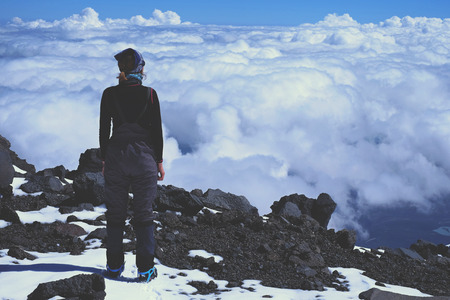 The girl in the mountains above the clouds people, success, skyの写真素材