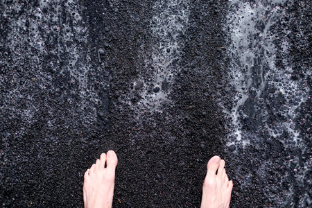 Feet on the black sand