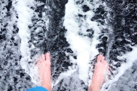 Feet on the black sand
