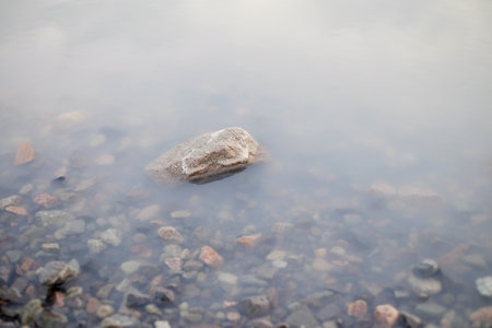 Milk water and stonesの写真素材