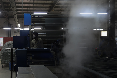 This is a photo of a dying machine operator in a dying mill. Which is situated in Dhaka, Bangladesh.