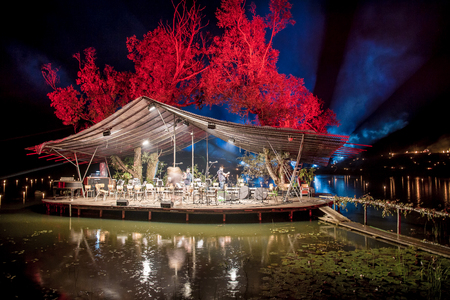 Platform floating on water with orchestra at nightの写真素材
