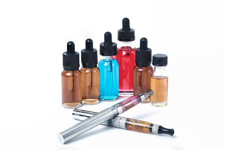 Two electronic cigarettes with glass e-liquid bottles on white backgroundの写真素材