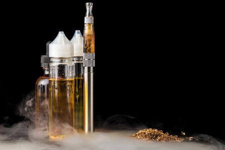 Electronic cigarette with bottles and grinded tobacco leavesの写真素材