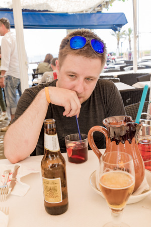 Man drinking sangria and reminiscingの写真素材