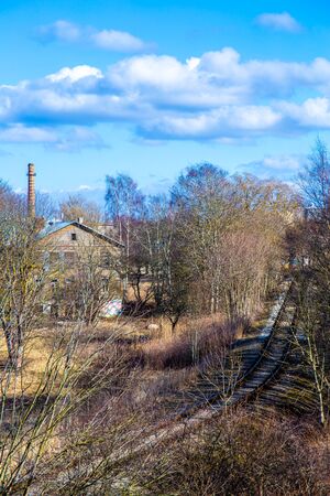 Rails next to old wooden houseの写真素材