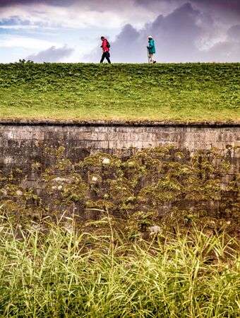 Elderly hiking on hillの写真素材