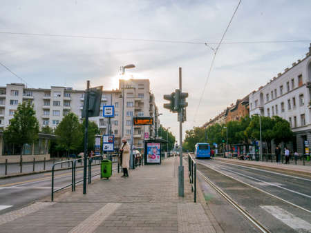 BUDAPEST, HUNGARY - OCTOBER 23, 2020: View on the traffic and people waiting for the bus and the tram on Szell Kalman ter square in Hungary, Budapest.のeditorial素材
