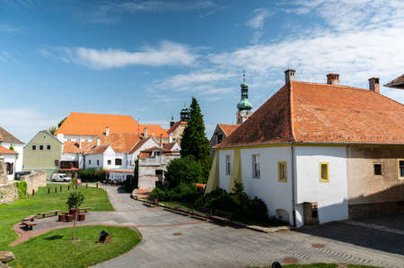 KOSZEG, HUNGARY - AUGUST 14, 2021: View on the Jurisics Castle and the yard as people walking in Koszeg, Hungary on a sunny cloudy summer day.のeditorial素材