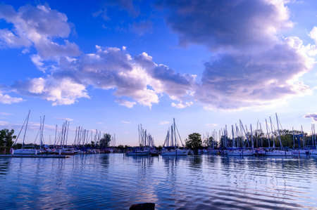 BADACSONY, HUNGARY - SEPTEMBER 18, 2021: Vew on the Balaton lake and the ships at the dock on during the sunset in Badacsony, Hungary.のeditorial素材