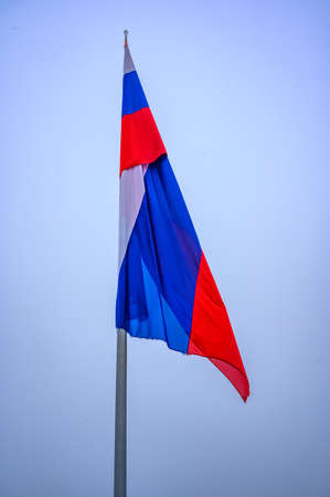Slovenian country flag against the blue sky. Isolated.の写真素材
