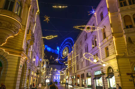 LJUBLJANA, SLOVENIA - JANUARY 01, 2022: Streets of Ljubljana during Christmas holiday with ornaments and festive lights at nightのeditorial素材