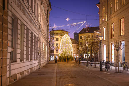 LJUBLJANA, SLOVENIA - JANUARY 01, 2022: Streets of Ljubljana during Christmas holiday with ornaments and festive lights at nightのeditorial素材