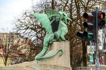 LJUBLJANA, SLOVENIA - FEBRUARY 15, 2022: View on the Famous Dragon bridge and the Dragon statue Zmajski now the symbol of Ljubljana, capital of Slovenia, Europe.のeditorial素材