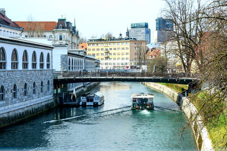 LJUBLJANA, SLOVENIA - FEBRUARY 15, 2022: Cityscape view on Ljubljanica river canal in Ljubljana old town with bridges and historic architecture in Sloveniaのeditorial素材