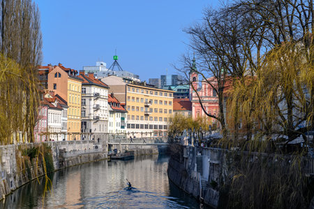 LJUBLJANA, SLOVENIA - FEBRUARY 15, 2022: Cityscape view on Ljubljanica river canal in Ljubljana old town with bridges and historic architecture in Sloveniaのeditorial素材