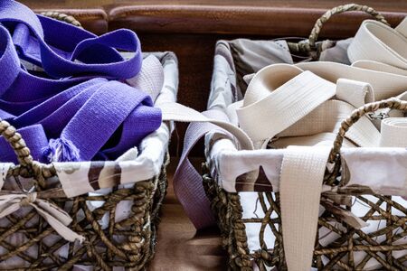 A variety of yoga props on a wooden table in the studio.