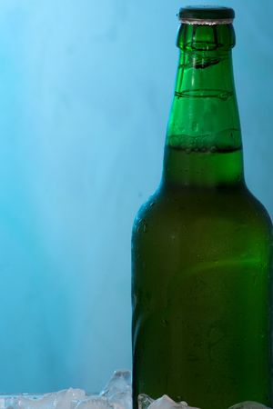 Beer in ice on blue abstract backgroundの写真素材