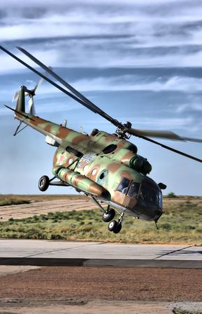 Military helicopter over land