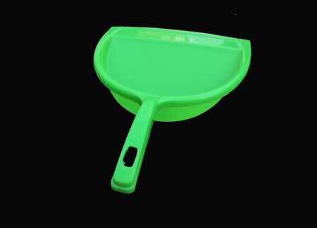 green garbage cleaner isolated on black backgroundの写真素材