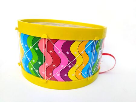 multi color children playing drum isolated on white backgroundの写真素材