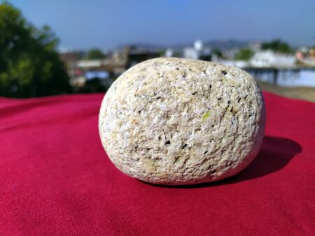 a white marbal stone put on red floor and nature backgroundの写真素材