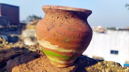 a red clay pot put on muddy placeの写真素材