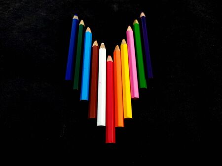 some colorful wooden pencil isolated on black background