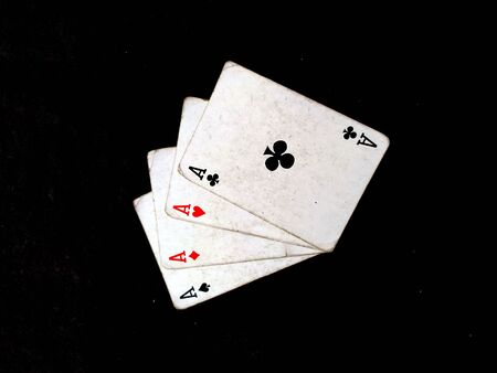 Set of four aces playing cards suits. Winning poker hand isolated on black background