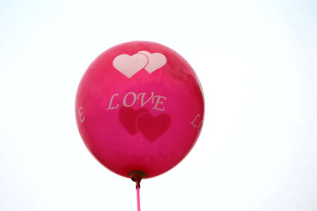 a red color balloon back green tree