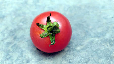 fresh red tomato isolated on stone backgroundの写真素材