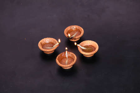 a clay lamp spread light on diwali festival